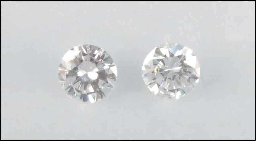 Appraisal: TWO UNMOUNTED DIAMONDS Round brilliant diamonds are F-G color VS