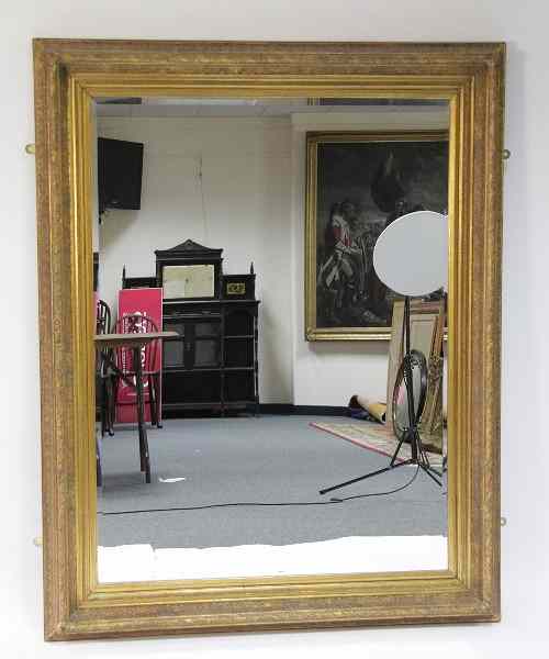 Appraisal: A large bevelled mirror with plaster gilt frame cm x