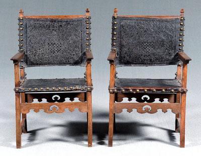 Appraisal: Two similar leather upholstered armchairs Baroque with open arms embossed