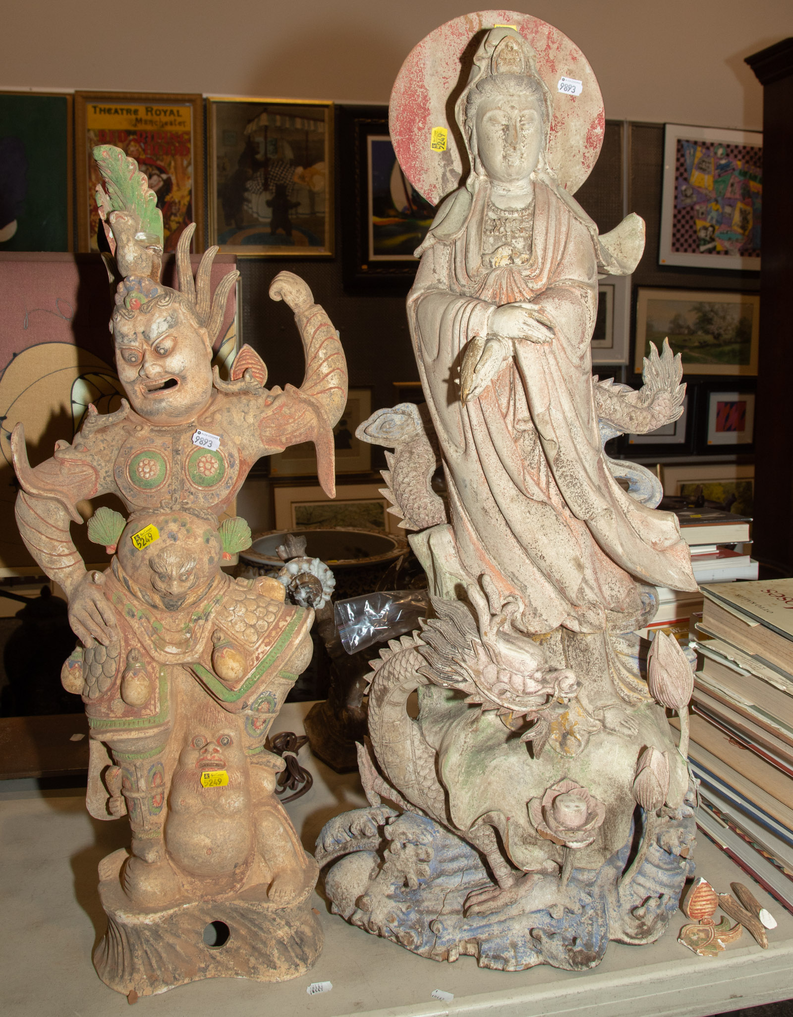 Appraisal: TWO CHINESE RELIGIOUS POTTERY FIGURES Comprising a carved and painted