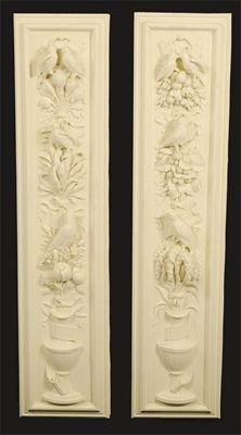 Appraisal: A pair of cream painted plaster panels of fruiting urns