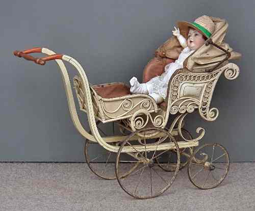 Appraisal: A Victorian child's cream painted wood and wickerwork pram with