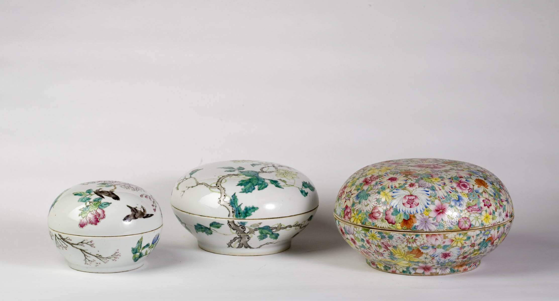 Appraisal: THREE CHINESE PORCELAIN FAMILLE ROSE CIRCULAR BOXES THE LARGEST WITH