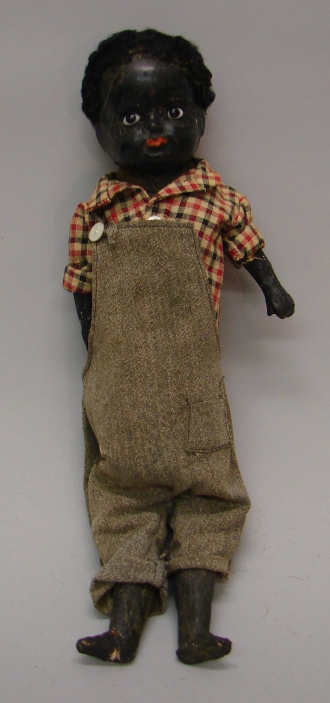 Appraisal: Unmarked black papier mache boy doll with stationary black pupiless