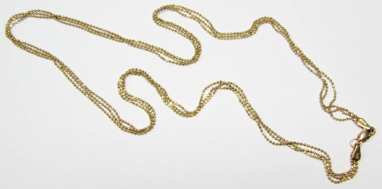 Appraisal: A slender link necklace with three strands of orbs with