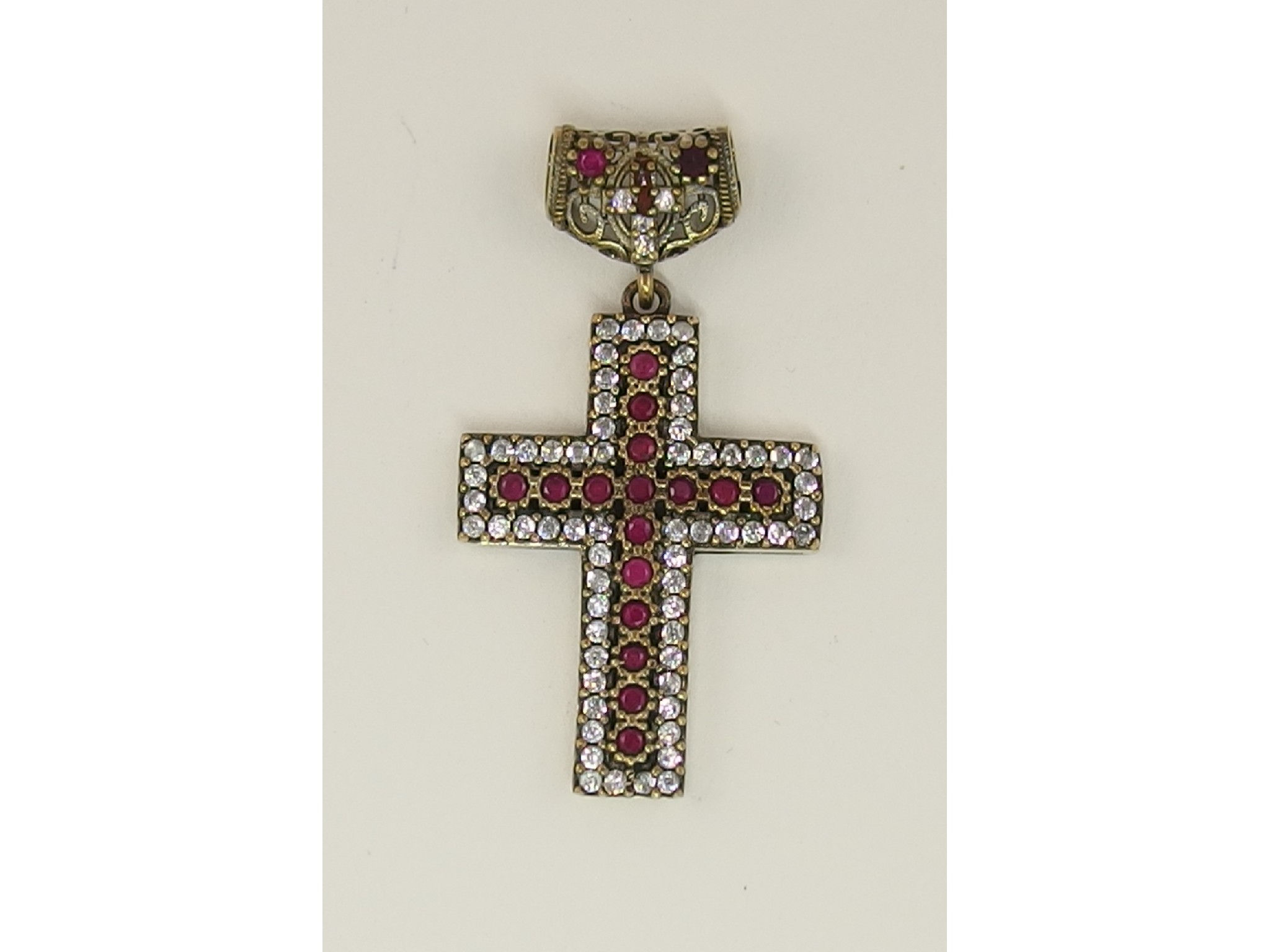 Appraisal: A ruby and topaz set silver cross pendant