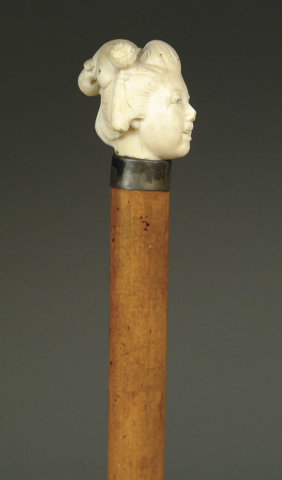 Appraisal: CARVED IVORY CANE WITH GEISHA HEAD Oriental woman s head