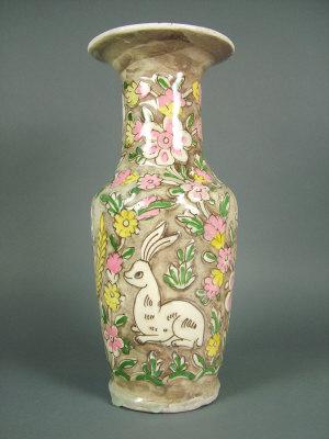 Appraisal: An Iranian Qajar vase the brown ground with raised decoration