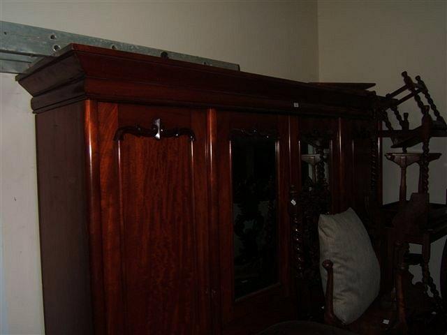 Appraisal: A Victorian mahogany wardrobe with two hanging cupboards to either