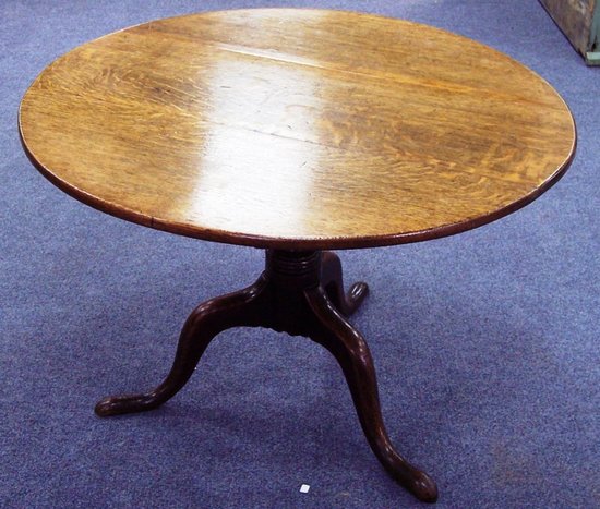 Appraisal: A circular oak table on a vase shaped column and