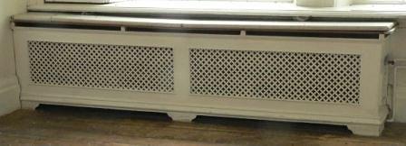 Appraisal: A double pierced cast radiator surround with pierced returns and