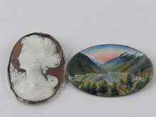 Appraisal: An oval brooch enamelled with a mountain scene signed Merok