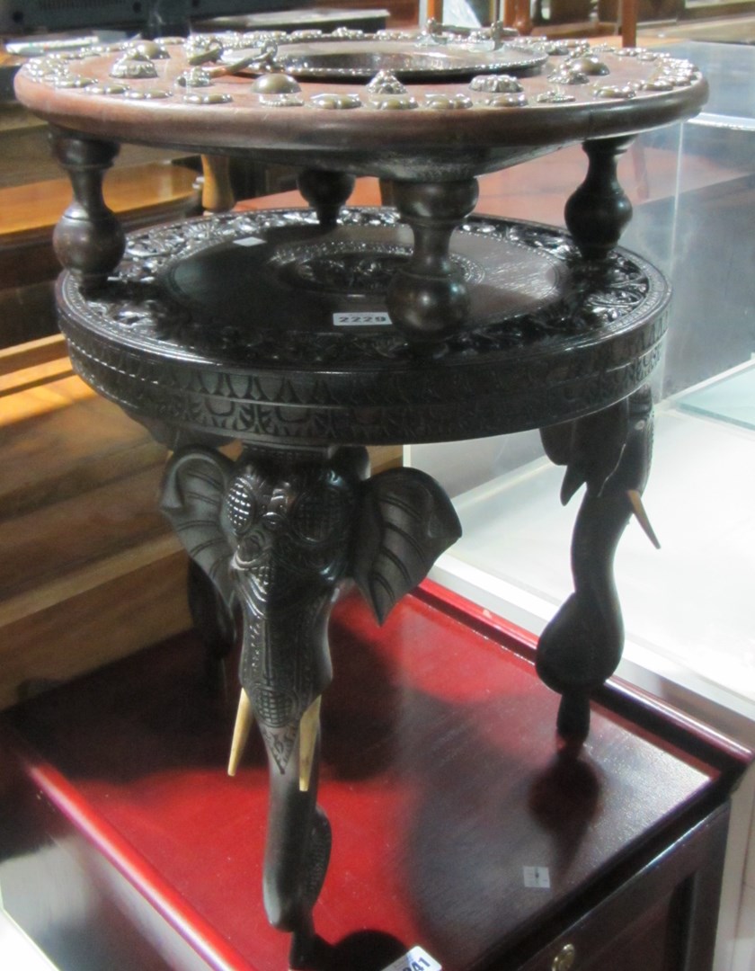 Appraisal: An early th century hardwood circular occasional table with elephant