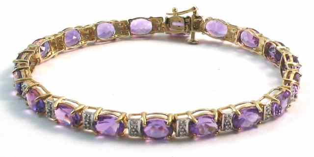 Appraisal: AMETHYST AND DIAMOND BRACELET k yellow gold set with oval-cut