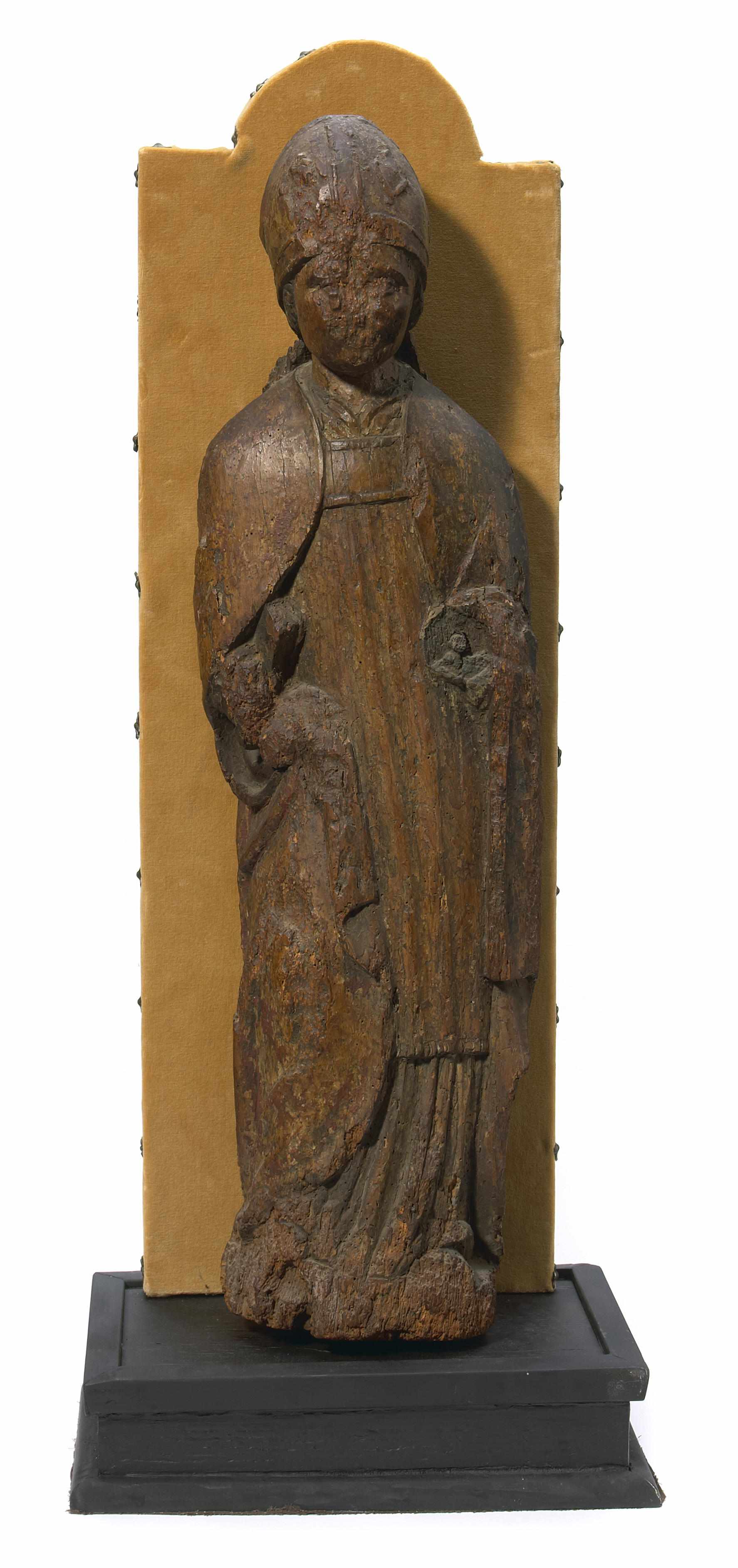 Appraisal: A Continental Gothic carved walnut figure of a bishop with