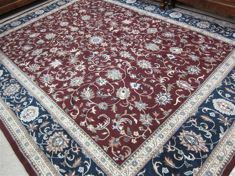 Appraisal: HAND KNOTTED ORIENTAL CARPET Indo-Persian Isfahan floral design on burgundy