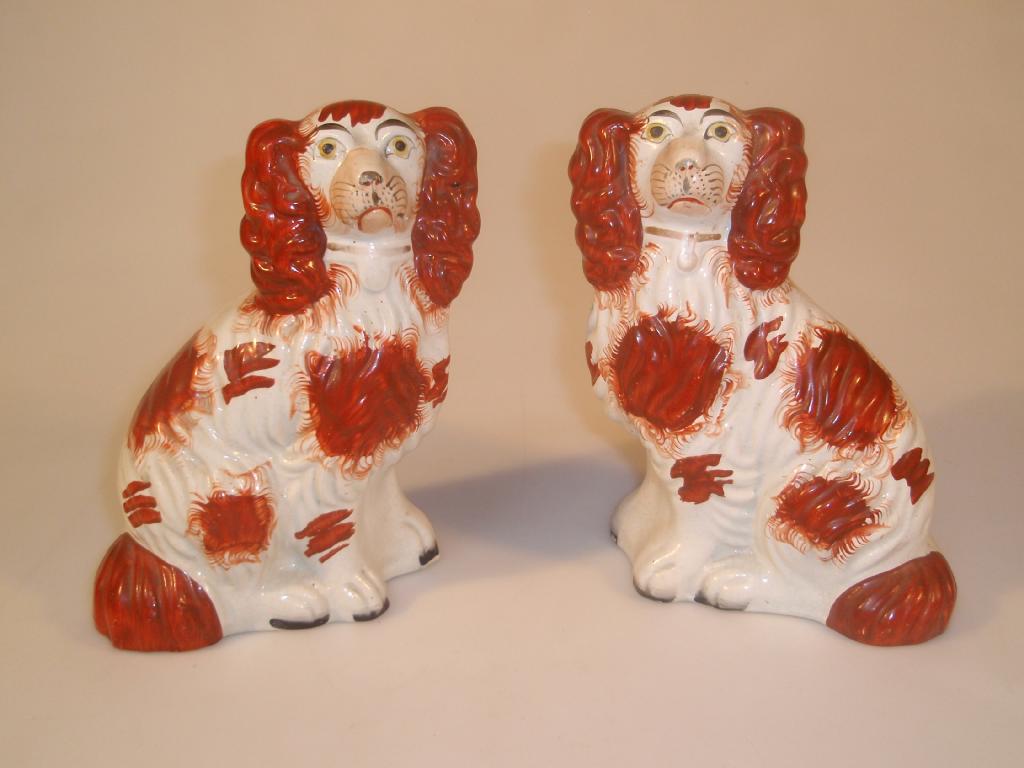 Appraisal: A pair of thC Staffordshire pottery figures of seated spaniels