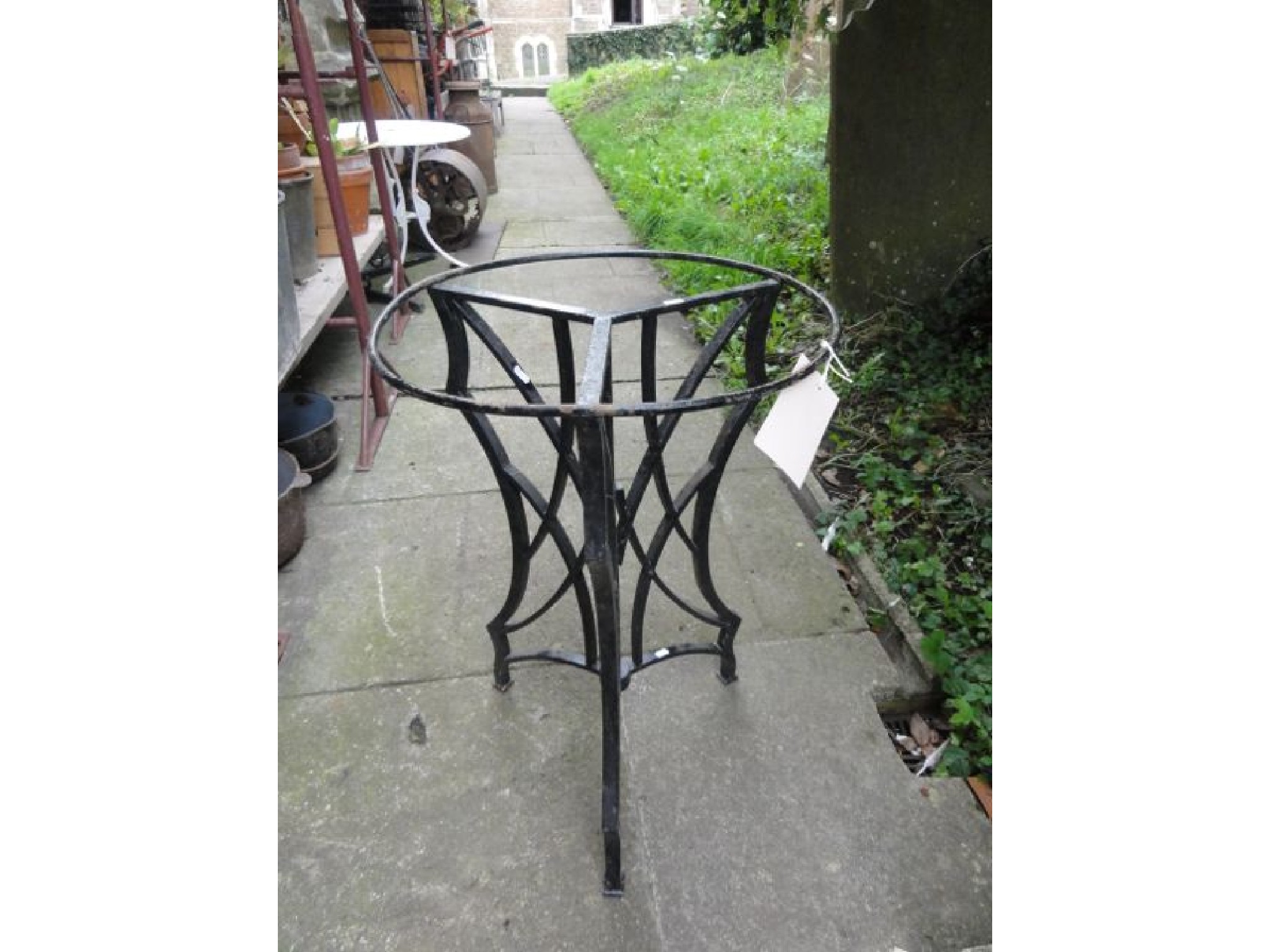 Appraisal: A small cast iron garden table with tri-form pierced and