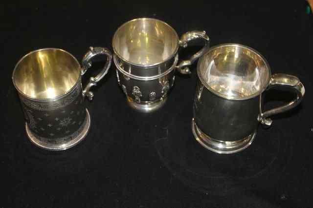 Appraisal: A COLLECTION OF THREE SILVER CHRISTENING MUGS in various shapes