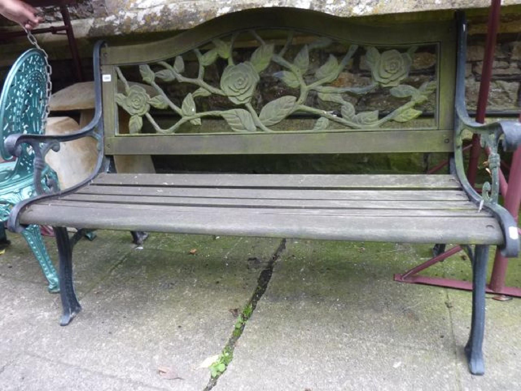 Appraisal: A garden bench with cast iron ends timber slatted seat