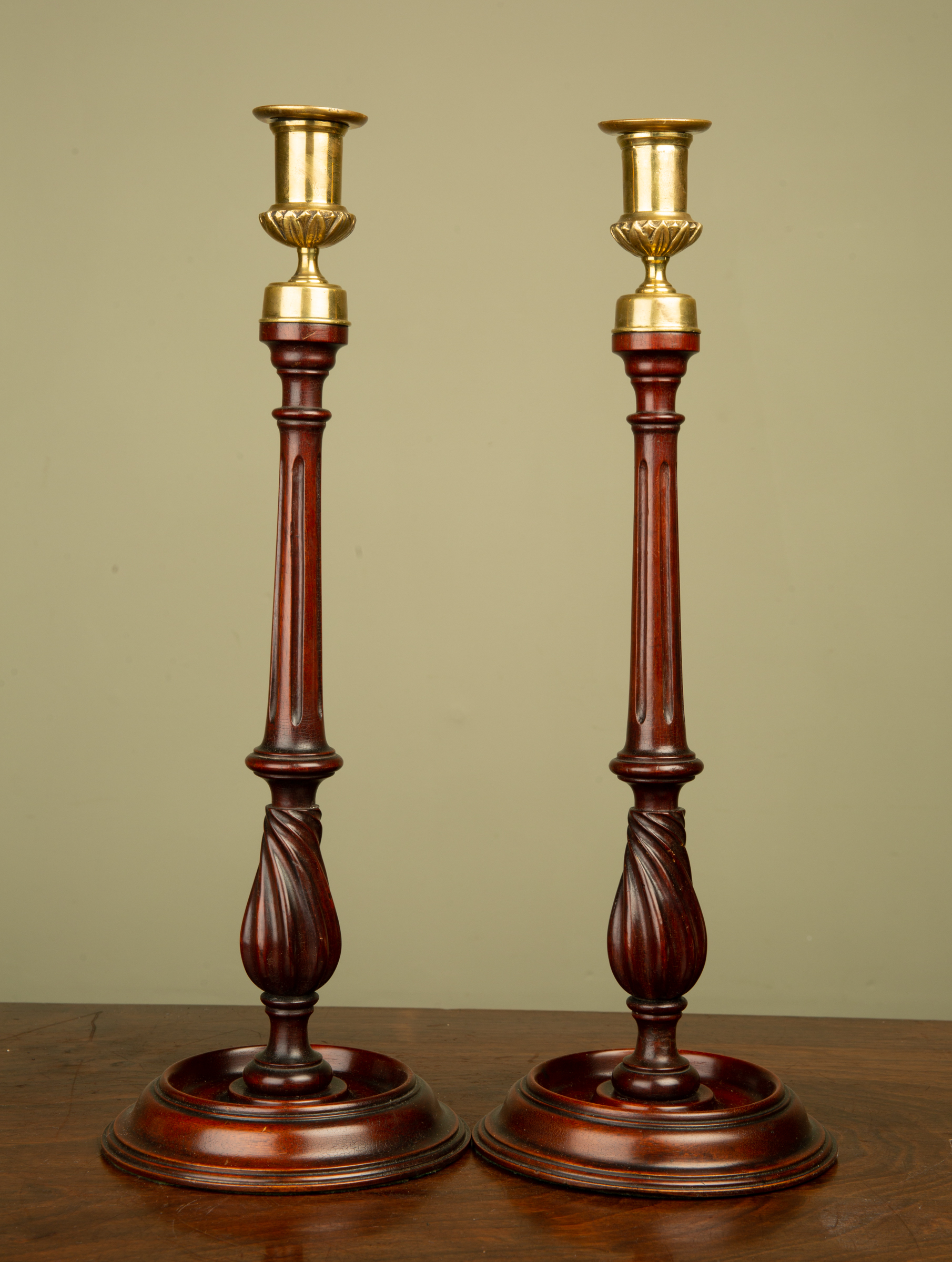 Appraisal: A pair mahogany and brass candle sticks with fluted stems