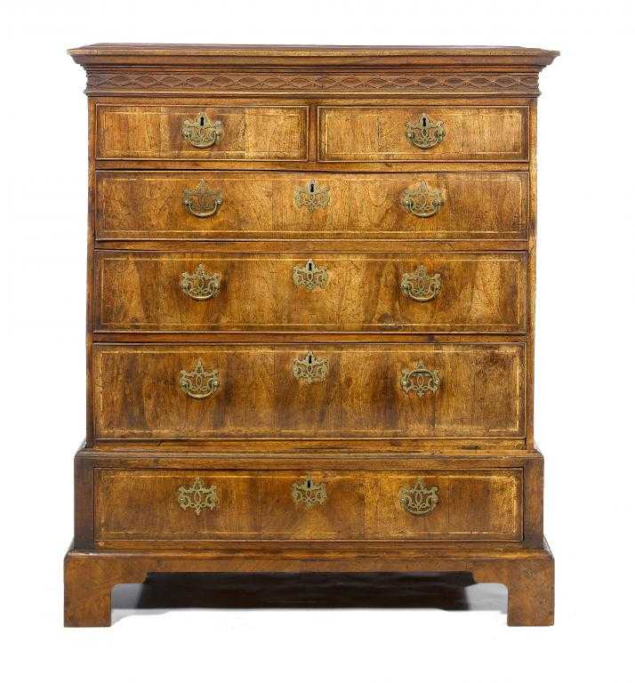 Appraisal: A GEORGE II WALNUT CHEST-ON-STAND the cornice above blind fret