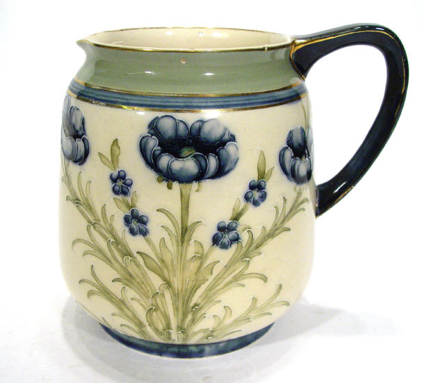 Appraisal: Moorcroft McIntyre pottery jug tube lined with poppy pattern painted