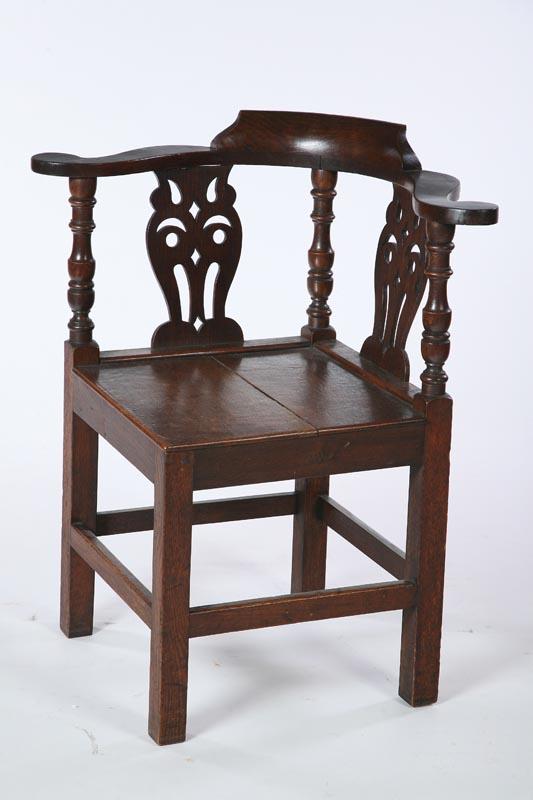 Appraisal: GEORGE III-STYLE CORNER OR ROUNDABOUT CHAIR English th century oak