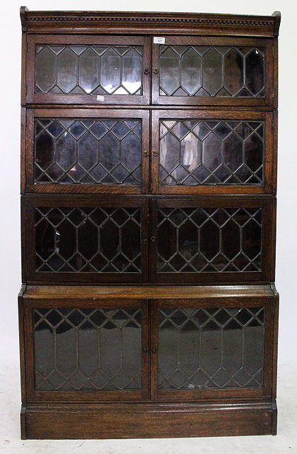 Appraisal: AN OAK FOUR TIER GLOBE WERNICKE BOOKCASE with leaded astragal