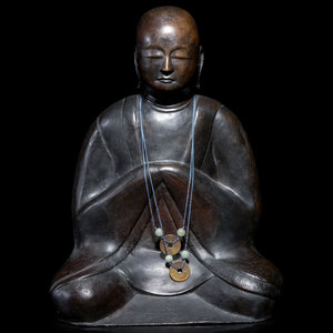 Appraisal: A Chinese Bronze Figure of a Monk depicting seated with