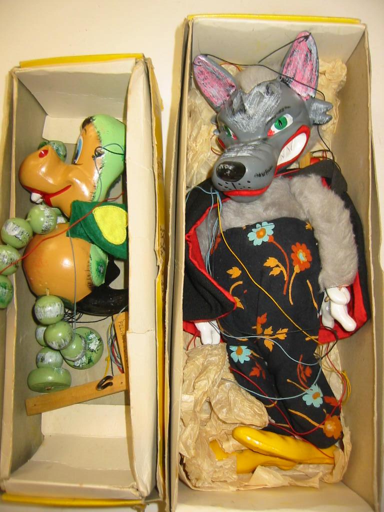 Appraisal: Two Pelham puppets Baby Dragon yellow snake charmer box and