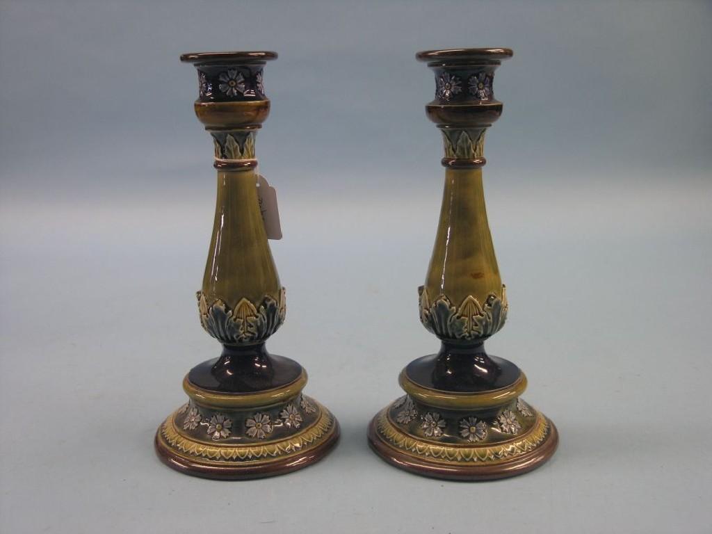 Appraisal: A pair of Doulton Lambeth glazed stoneware candlesticks baluster stems