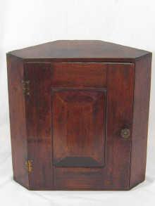 Appraisal: A small mahogany corner cupboard with fielded door panel x