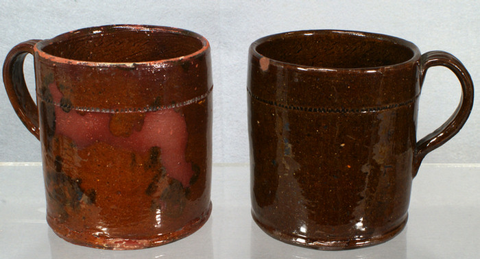 Appraisal: glazed redware mugs one with manganese decoration minor chips and