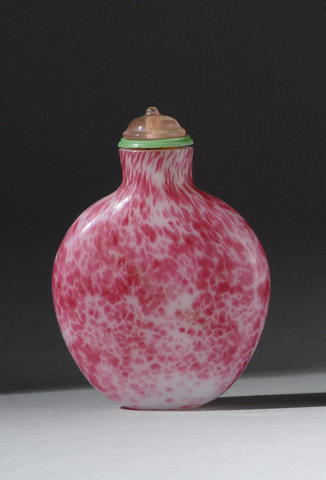 Appraisal: MOTTLED GLASS SNUFF BOTTLE th CenturyIn flattened ovoid form with