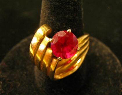 Appraisal: karat yellow gold and synthetic ruby ringRound cut synthetic ruby