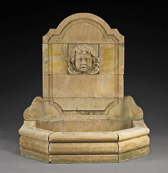 Appraisal: A French Baroque style limestone fountain The arched back centering