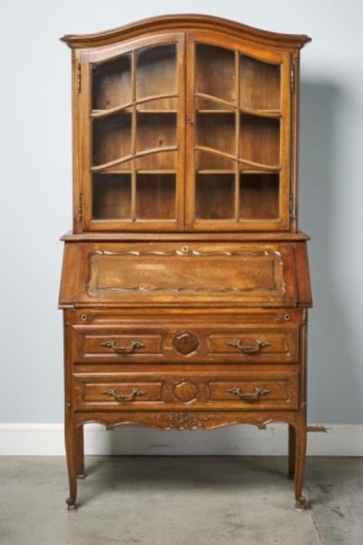 Appraisal: An oak drop front secr taire bookcase with the arch-top