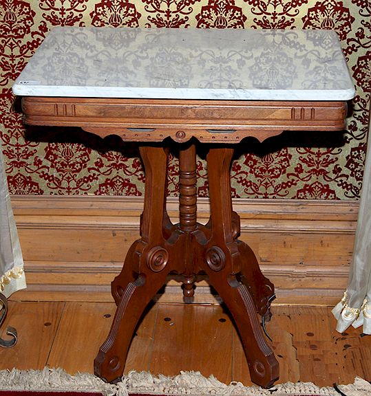 Appraisal: Marble Top Victorian Table A walnut Victorian parlor table on