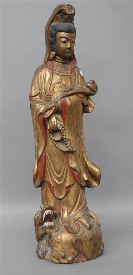 Appraisal: A GILT AND POLYCHROMED CARVED CHINESE FIGURE Woman standing on