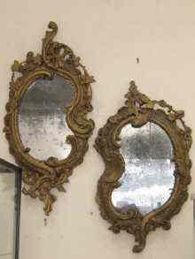 Appraisal: Two rococo carved wood and gesso wall mirrors with original