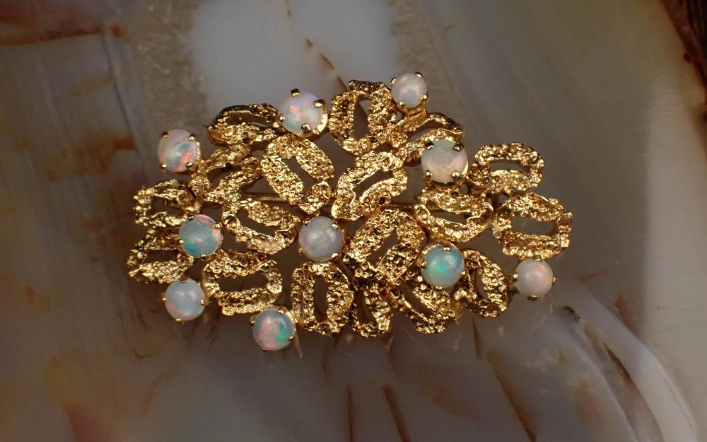 Appraisal: OPAL AND YELLOW GOLD OPENWORK BROOCH The textured K yellow