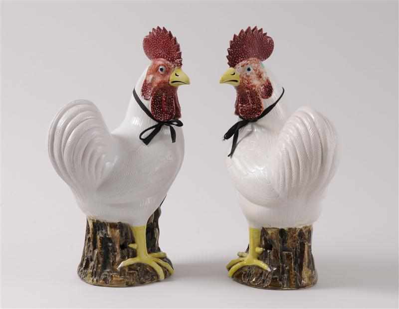 Appraisal: PAIR OF CHINESE BISCUIT-GLAZED PORCELAIN FIGURES OF ROOSTERS Each astride