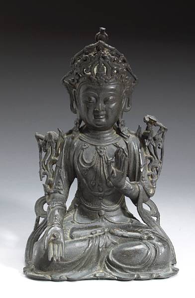 Appraisal: A seated bronze figure of Guanyin Ming Dynasty The smiling