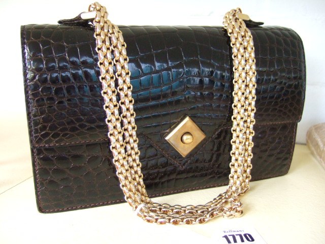 Appraisal: A brown crocodile skin handbag with gold plated chain strap