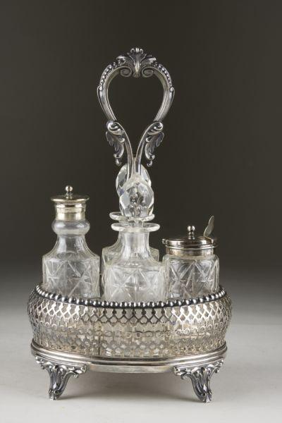 Appraisal: Silverplate Cut Glass Cruet Set th century pierced oblong basket