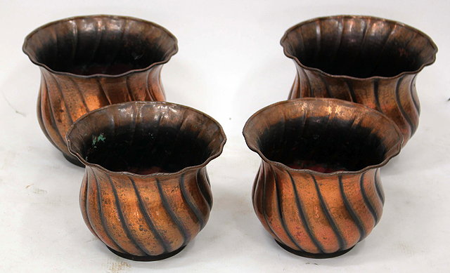 Appraisal: FOUR EARLY TH CENTURY HAMMERED COPPER JARDINIERS with flaring rims