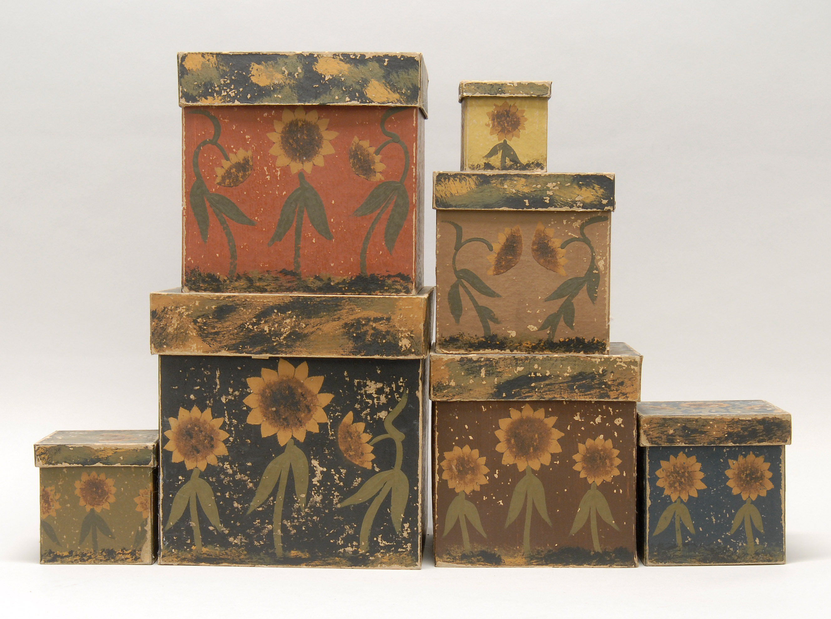 Appraisal: SET OF SEVEN NESTING WALLPAPER BOXES with sunflower decoration Height