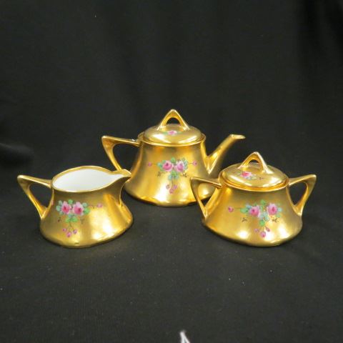 Appraisal: Pickard Handpainted Gold EncrustedPorcelain Tea Set roses on textured gold