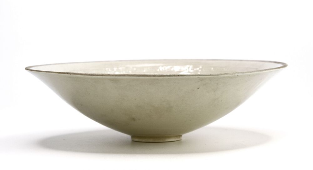 Appraisal: Moulded 'Ding' 'Phoenix' Bowl The shallow rounded sides supported on